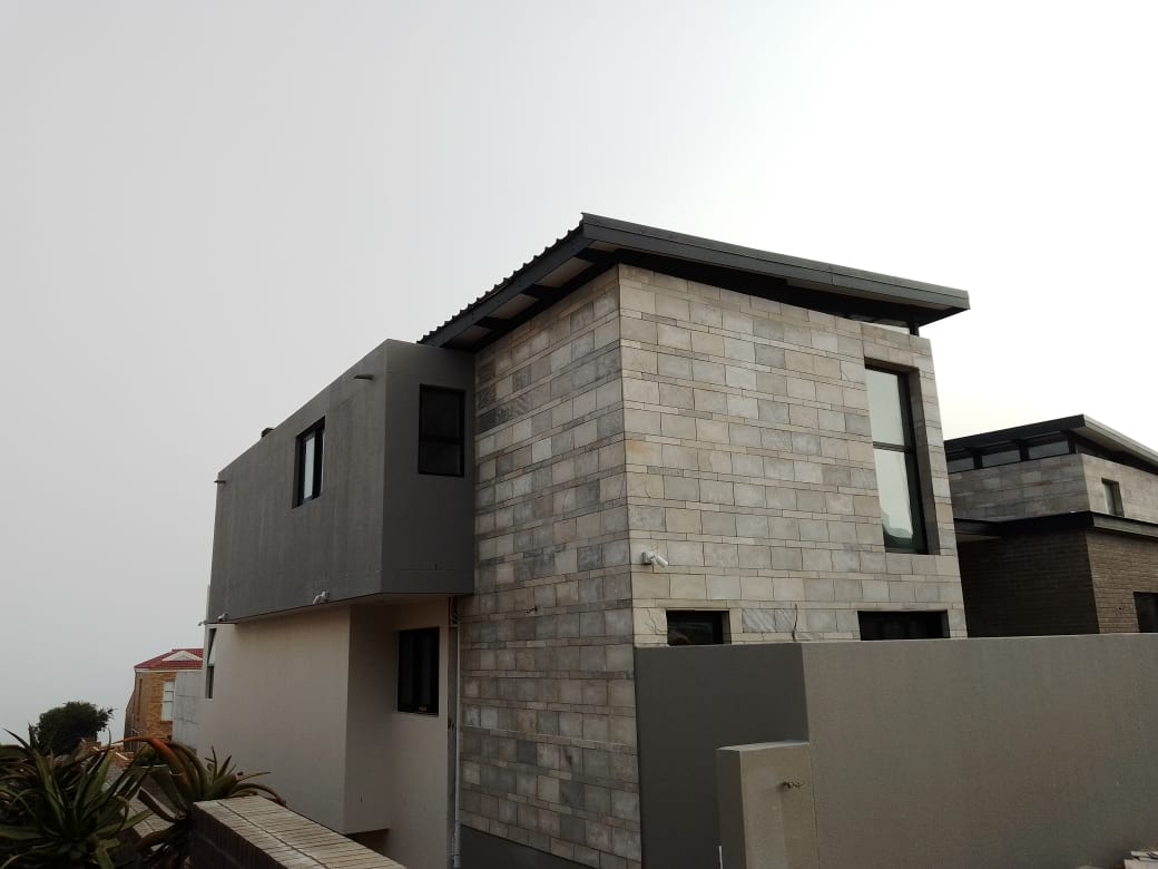 Modern architectural home with natural stone cladding